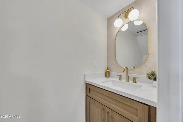 a bathroom with a sink vanity and a mirror