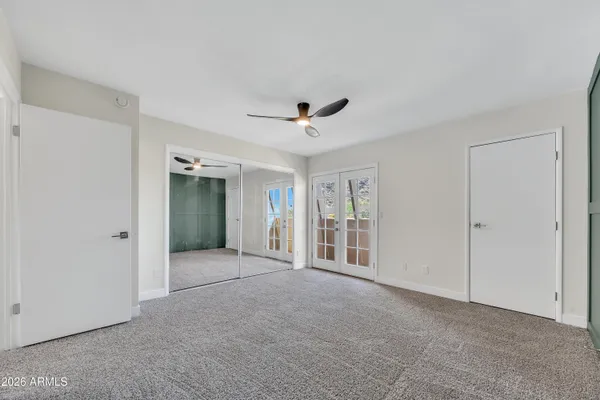 a view of an empty room with a ceiling fan