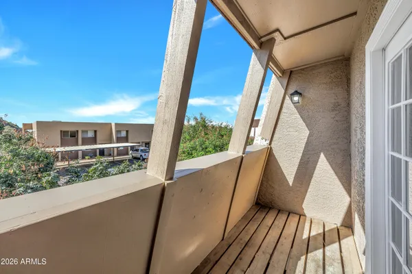 a view of a balcony with wooden floor
