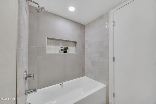 a bathroom with a bathtub and shower