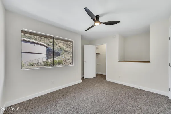 a view of a livingroom with a ceiling fan and window