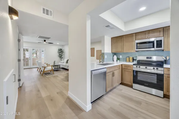a kitchen with stainless steel appliances a stove a sink and a refrigerator