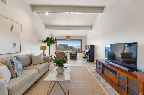 a view of a dining room with furniture wooden floor and a chandelier