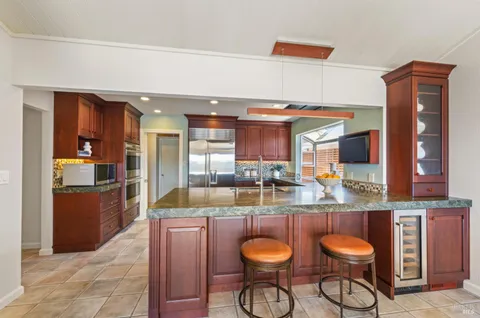 a kitchen with stainless steel appliances granite countertop a sink and stove