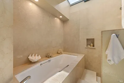 a spacious bedroom with a bed and a window