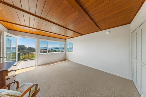 a bathroom with a granite countertop tub a double vanity sink and mirror