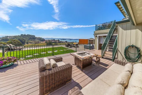 a view of a patio with table and chairs under an umbrella