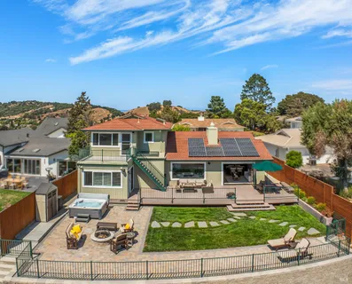 an aerial view of house with yard and lake view