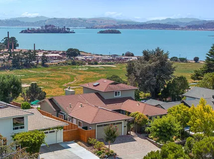 an aerial view of a houses with a lake view