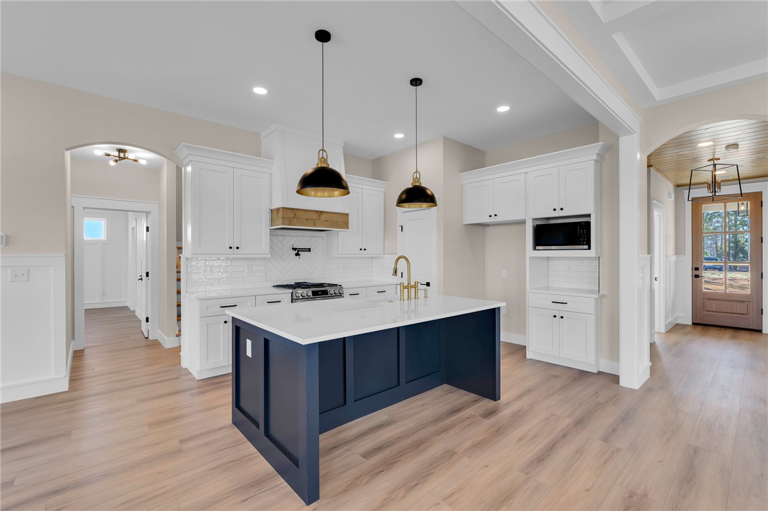 4546 Flat Rock Road Iva, SC 29655 - Photo 11 of 28 This bright kitchen features a spacious island and gleaming wood floors.