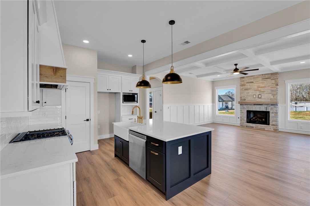 4546 Flat Rock Road Iva, SC 29655 - Photo 13 of 28 This open concept living area seamlessly connects the kitchen and living room, offering a bright and inviting space.