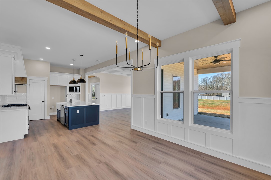 4546 Flat Rock Road Iva, SC 29655 - Photo 15 of 28 This bright kitchen with natural wood flooring seamlessly flows into a spacious living area.