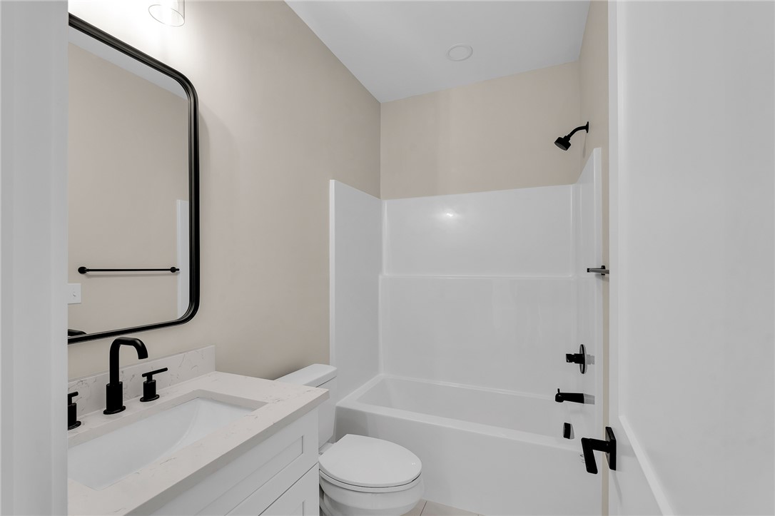4546 Flat Rock Road Iva, SC 29655 - Photo 19 of 28 This sleek bathroom features a modern vanity with elegant fixtures and a pristine shower-tub combination.