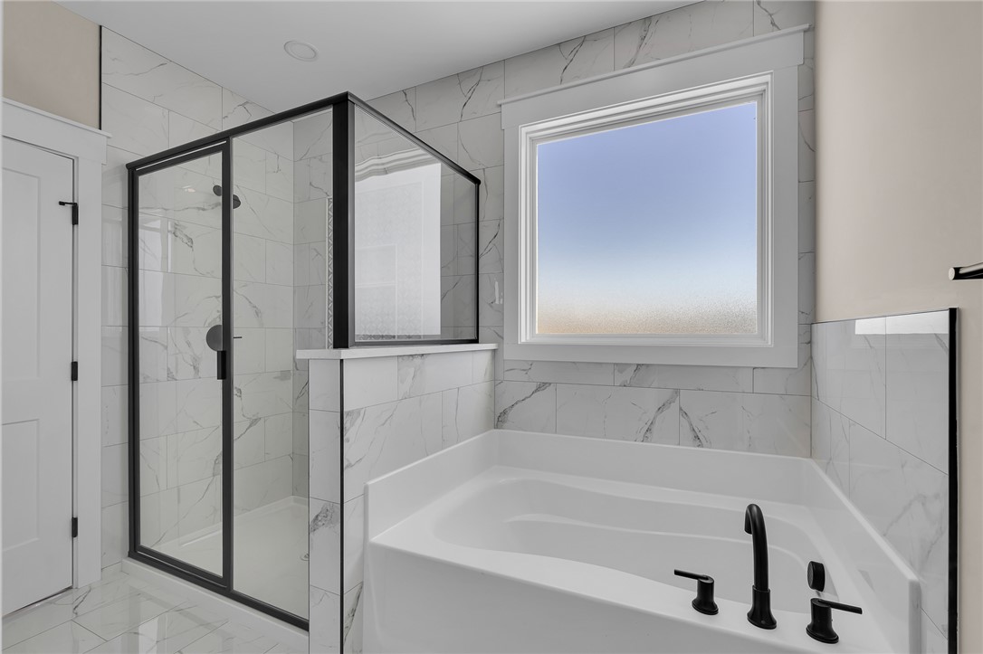 4546 Flat Rock Road Iva, SC 29655 - Photo 25 of 28 This sleek bathroom boasts a spacious tub and shower, offering a tranquil retreat.