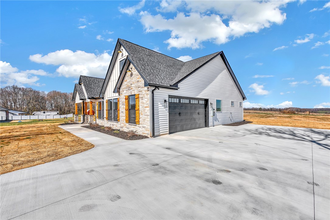 4546 Flat Rock Road Iva, SC 29655 - Photo 5 of 28 This newly constructed home showcases a modern farmhouse design with a spacious driveway.