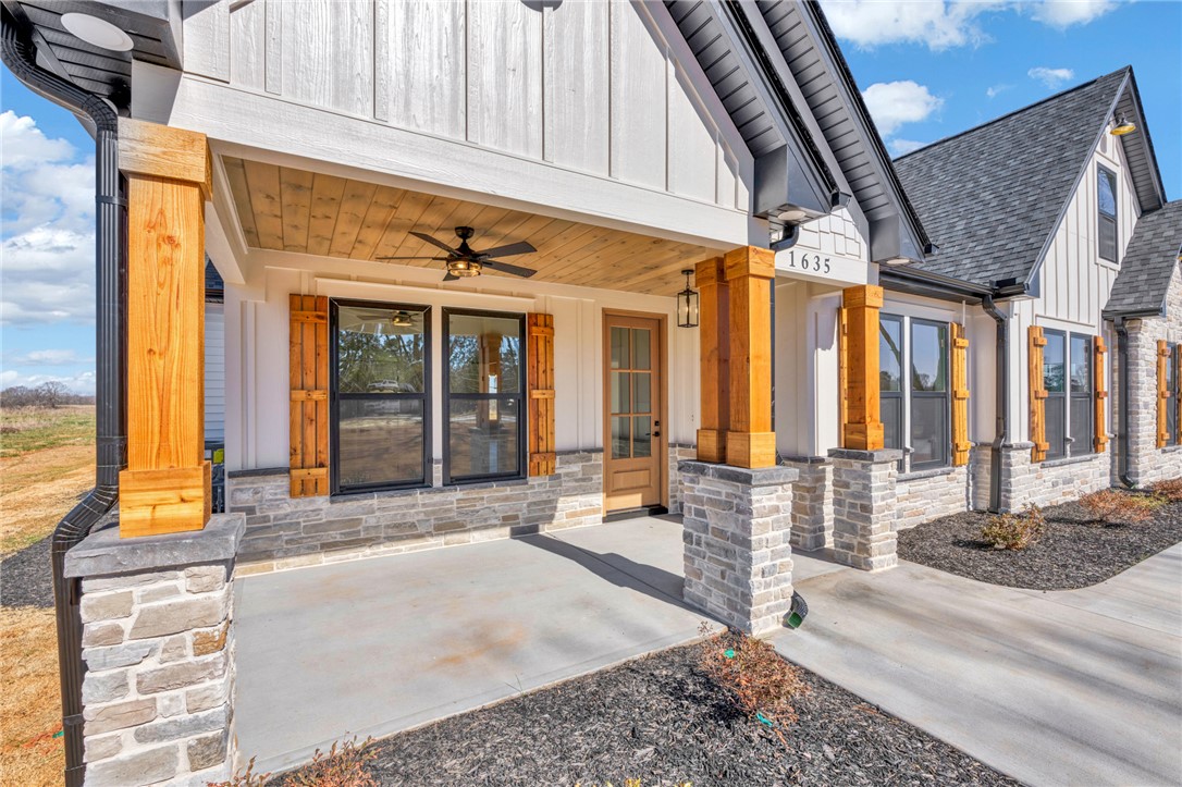 4546 Flat Rock Road Iva, SC 29655 - Photo 6 of 28 This charming home showcases a welcoming front porch with natural wood accents and durable stone details.