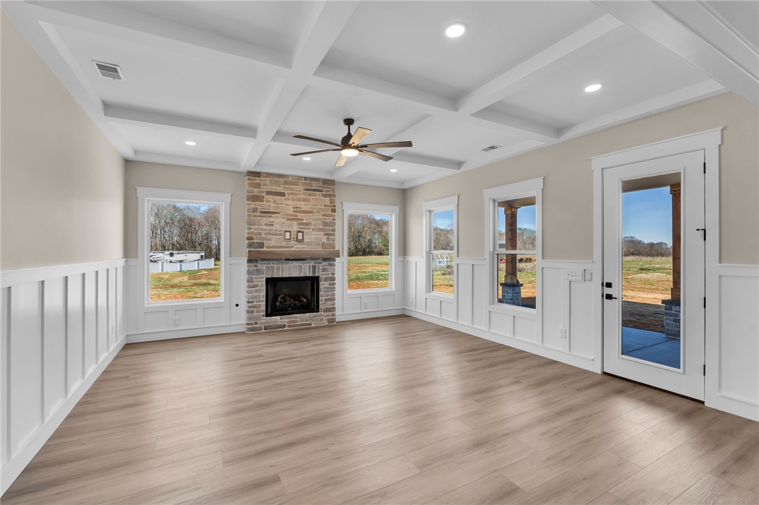 4546 Flat Rock Road Iva, SC 29655 - Photo 8 of 28 This expansive living area features architectural ceilings, a cozy fireplace, and abundant natural light.
