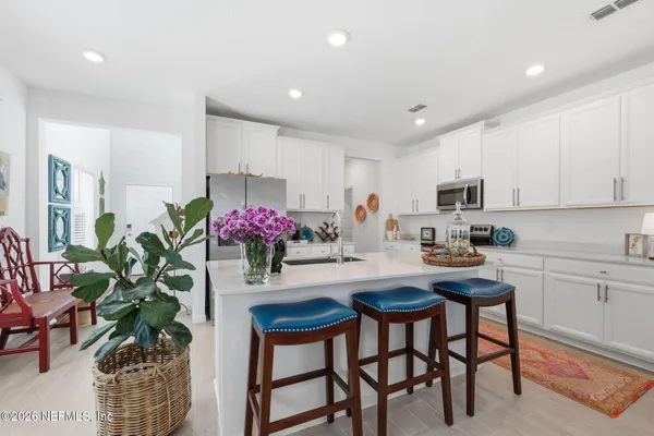 a dining room with furniture and flowers