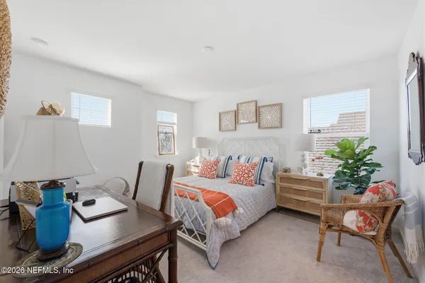 a bedroom with bed and a potted plant