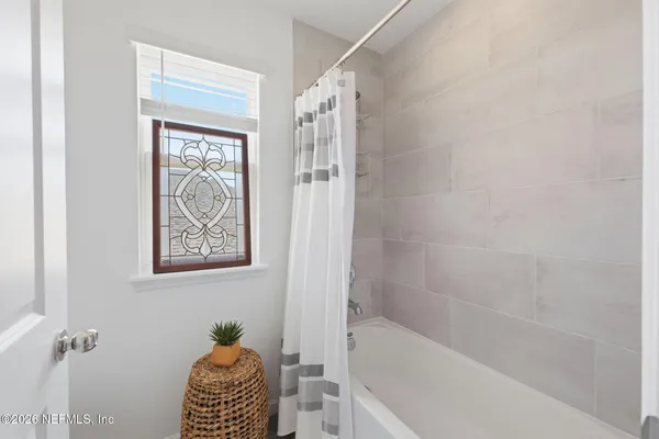 a bed room with a bed and a chair