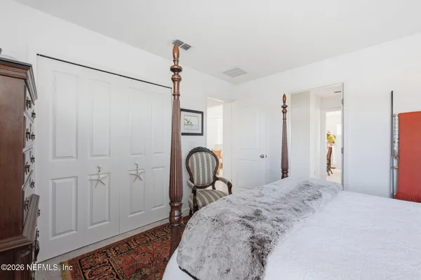 a bedroom with furniture and a window