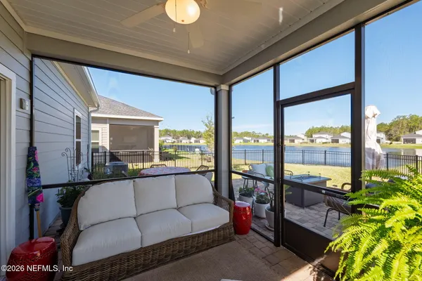 a view of a house with backyard porch and sitting area