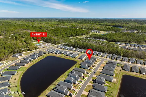 an aerial view of a house with swimming pool and outdoor seating