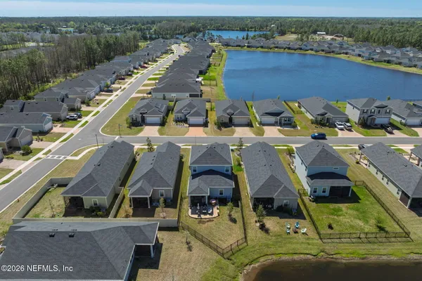 an aerial view of a house with a yard