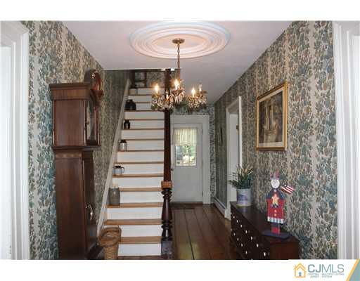 972 New Dover Road Edison, NJ 08820 - Photo 2 of 20 a view of entryway with a front door and wooden floor