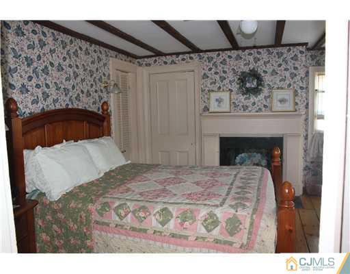 972 New Dover Road Edison, NJ 08820 - Photo 13 of 20 a bedroom with a bed and a fireplace