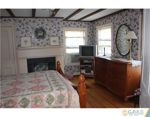 972 New Dover Road Edison, NJ 08820 - Photo 14 of 20 a bedroom with a bed and a fireplace