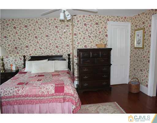 972 New Dover Road Edison, NJ 08820 - Photo 15 of 20 a bedroom with a bed and a dresser