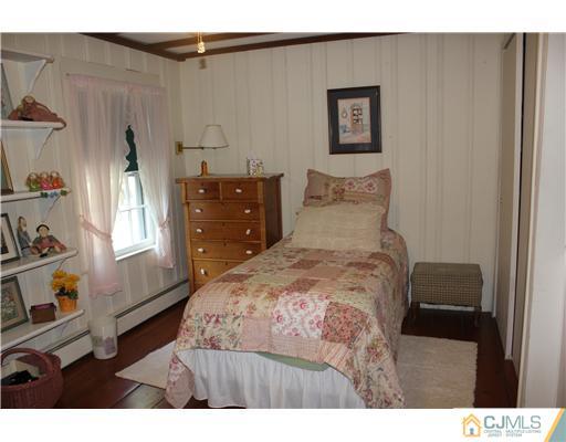 972 New Dover Road Edison, NJ 08820 - Photo 16 of 20 a bedroom with a bed and a dresser