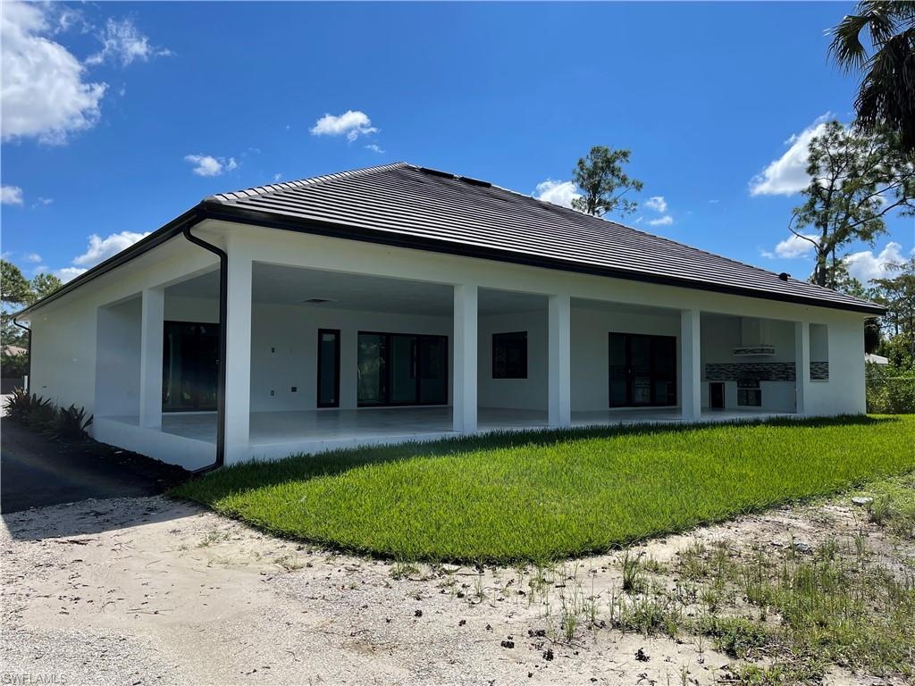 3203 68th Street Southwest Naples, FL 34105 - Photo 32 of 34 a view of a house with a backyard