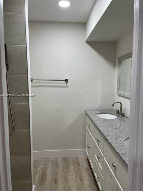 7753 Courtyard Run West, Unit 7753 Boca Raton, FL 33433 - Photo 12 of 15 a bathroom with a granite countertop sink and mirror