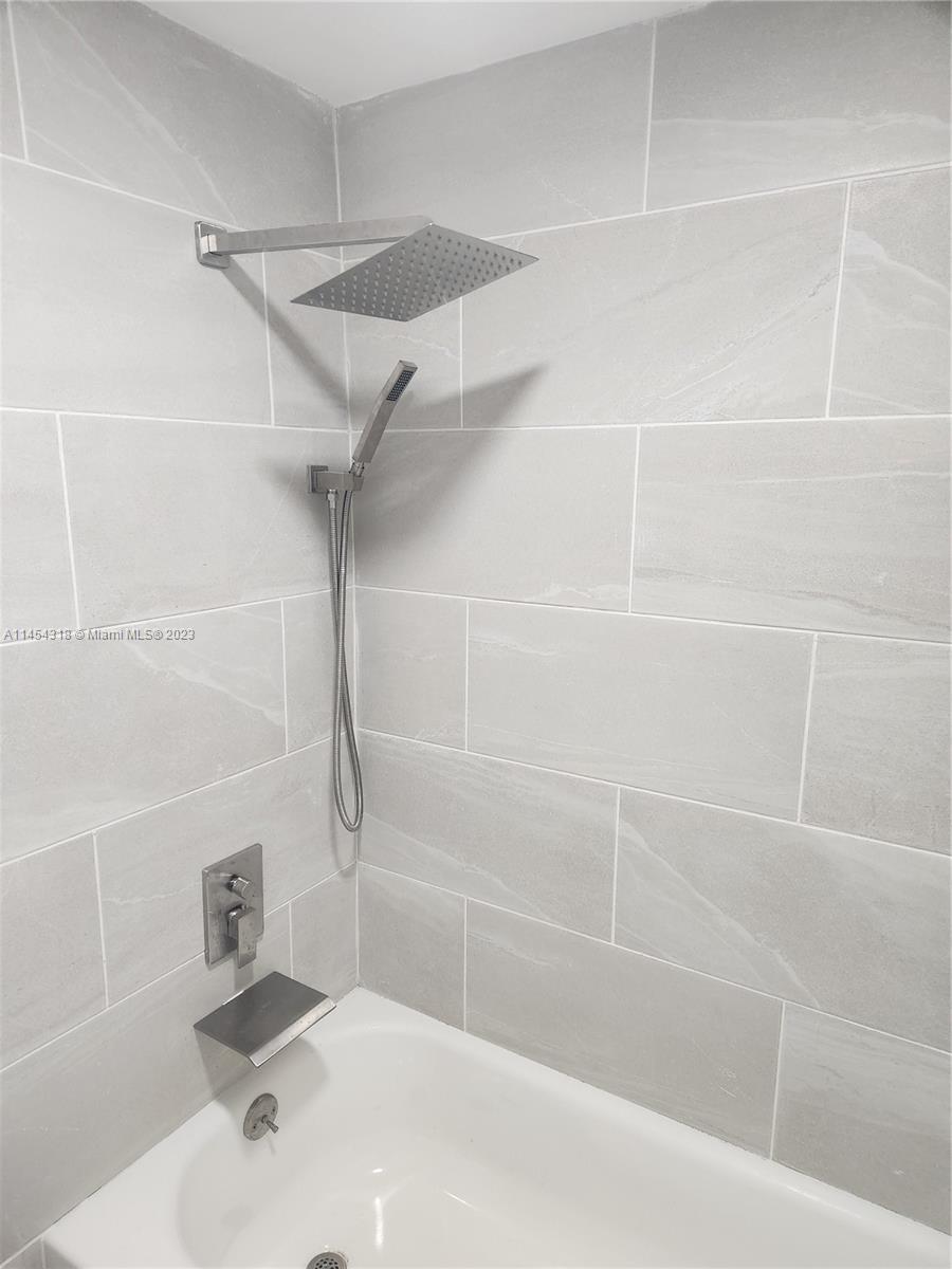 7753 Courtyard Run West, Unit 7753 Boca Raton, FL 33433 - Photo 14 of 15 a bathroom with a shower and a sink