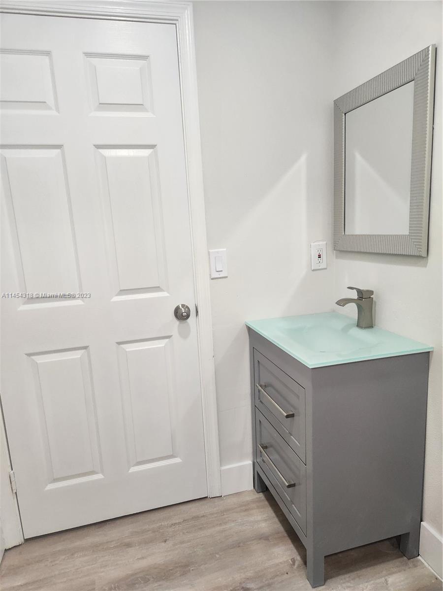 7753 Courtyard Run West, Unit 7753 Boca Raton, FL 33433 - Photo 15 of 15 a bathroom with a double vanity sink and mirror