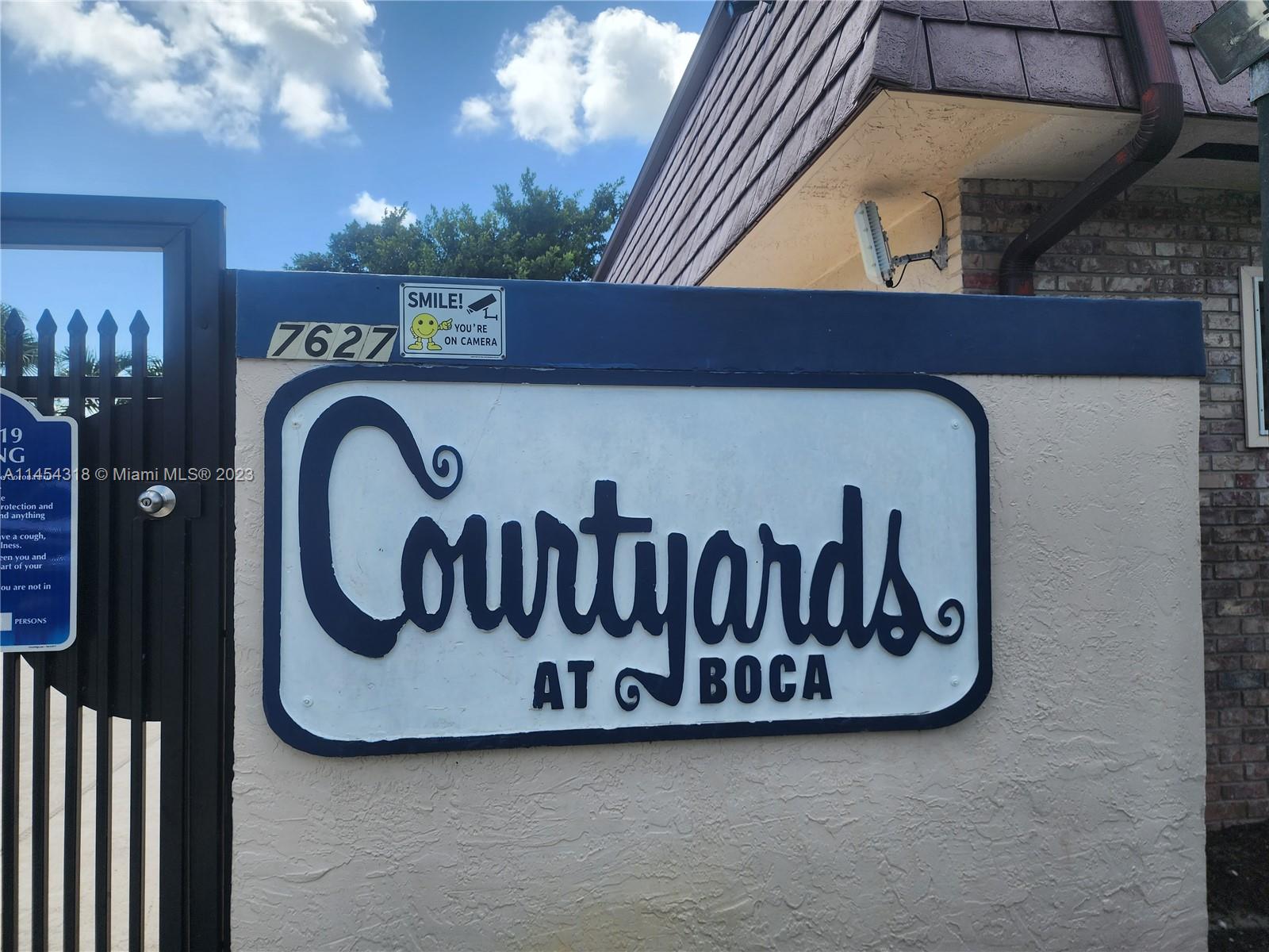 7753 Courtyard Run West, Unit 7753 Boca Raton, FL 33433 - Photo 3 of 15 a view of a door with a sign