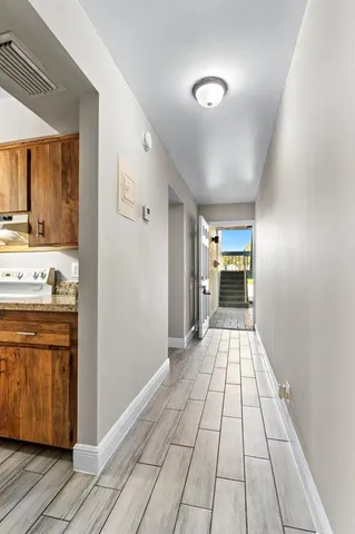 a view of a hallway with a kitchen