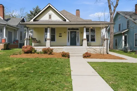 a front view of a house with yard and green space