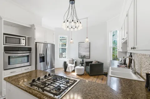 a living room with furniture flat screen tv and a table