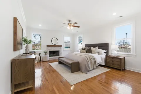 a spacious bedroom with a bed and a fireplace