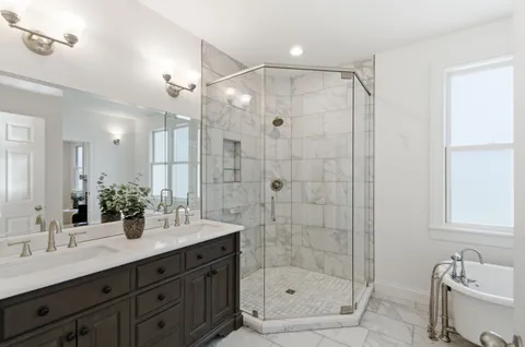a bathroom with a shower sink and mirror
