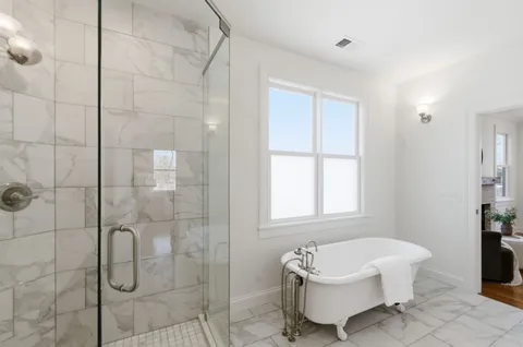a bathroom with a bathtub and shower