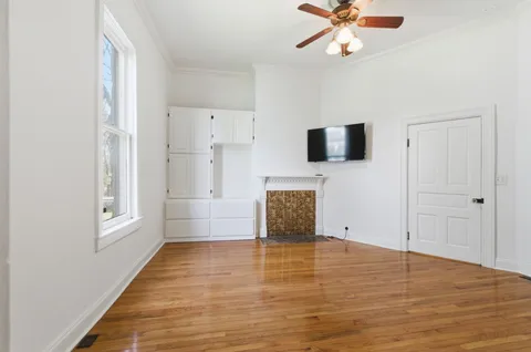 wooden floor in an empty room with a window