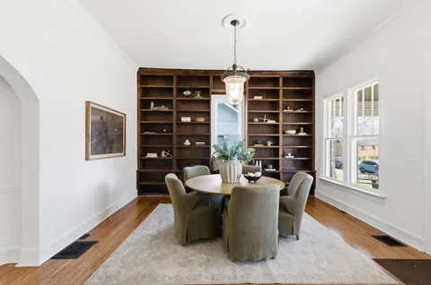 a dining room with furniture and wooden floor