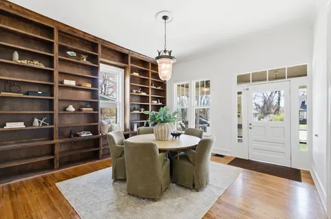 a dining room with a table and chairs