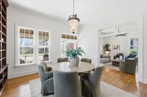 a dining room with furniture window and wooden floor