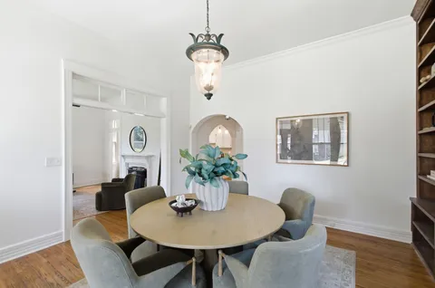 a dining room with furniture and wooden floor