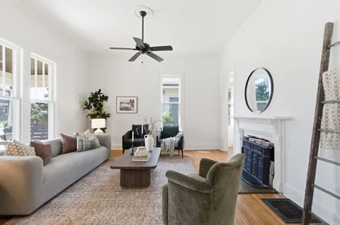 a living room with furniture a window and a fireplace